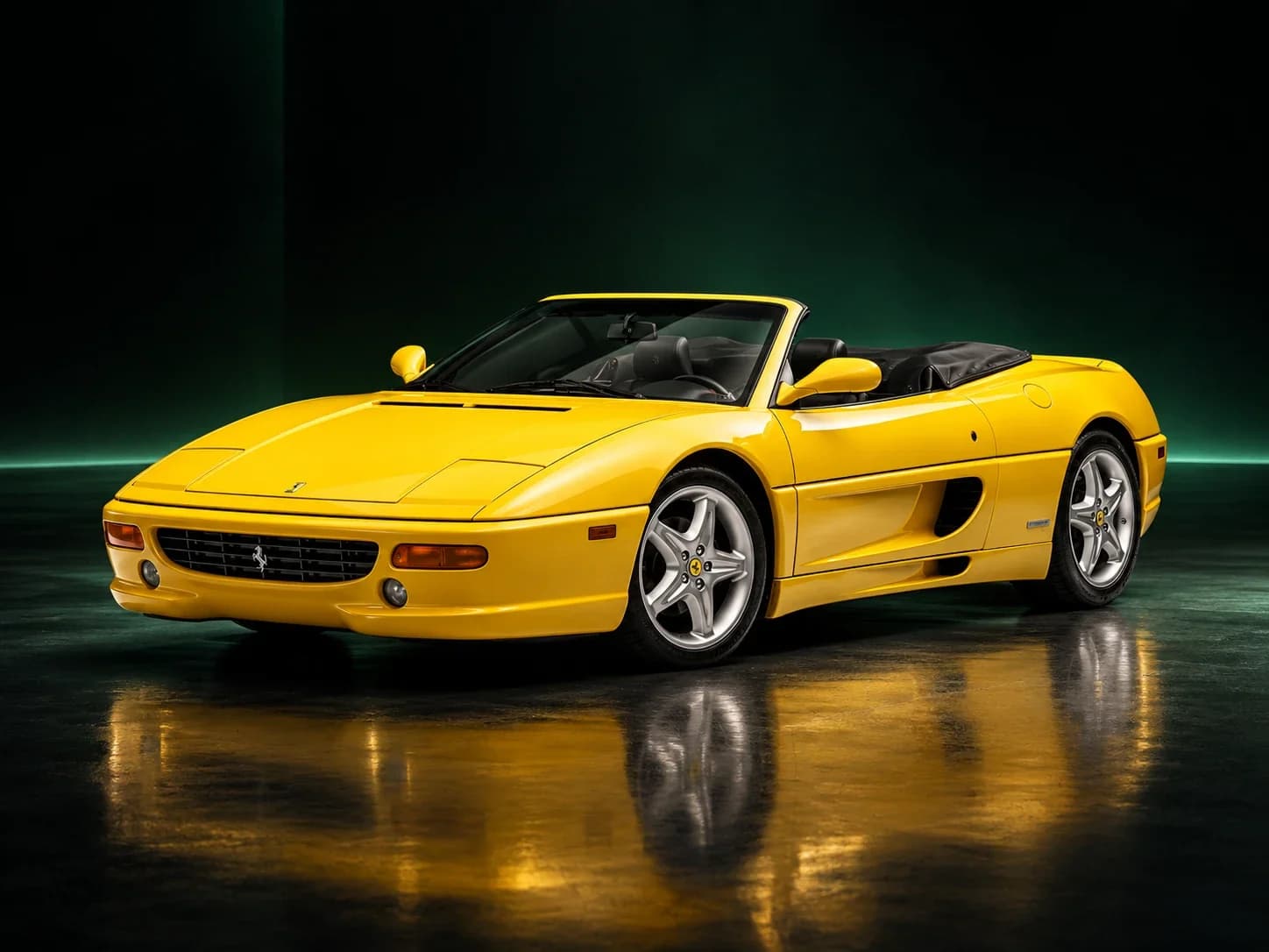 A yellow Ferrari F355 Spider in a dark studio